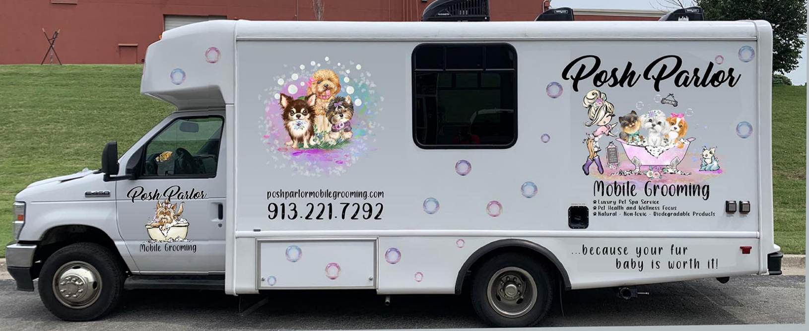 A white food truck with bubbles on the side.